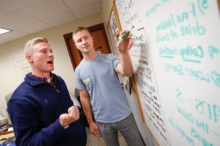 students working at a whiteboard